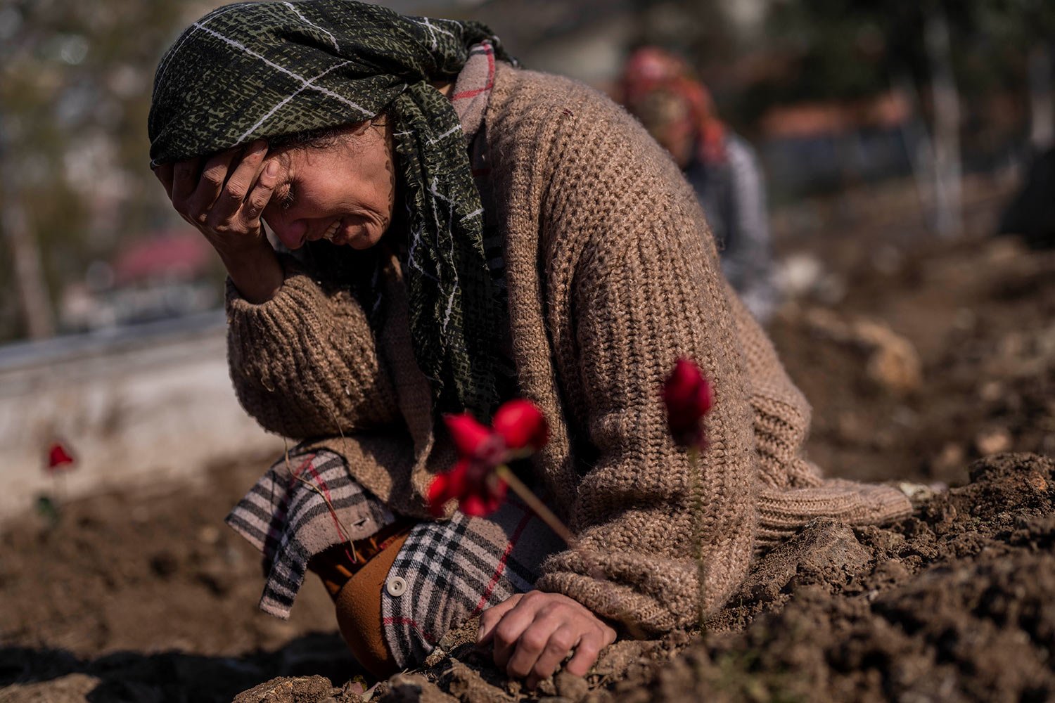  A member of the Vehibe family mourns a relative during the burial of one of the earthquake victims that struck a border region of Turkey and Syria five days ago in Antakya, southeastern Turkey, on Saturday, February 11, 2023. (AP Photo/Bernat Armang