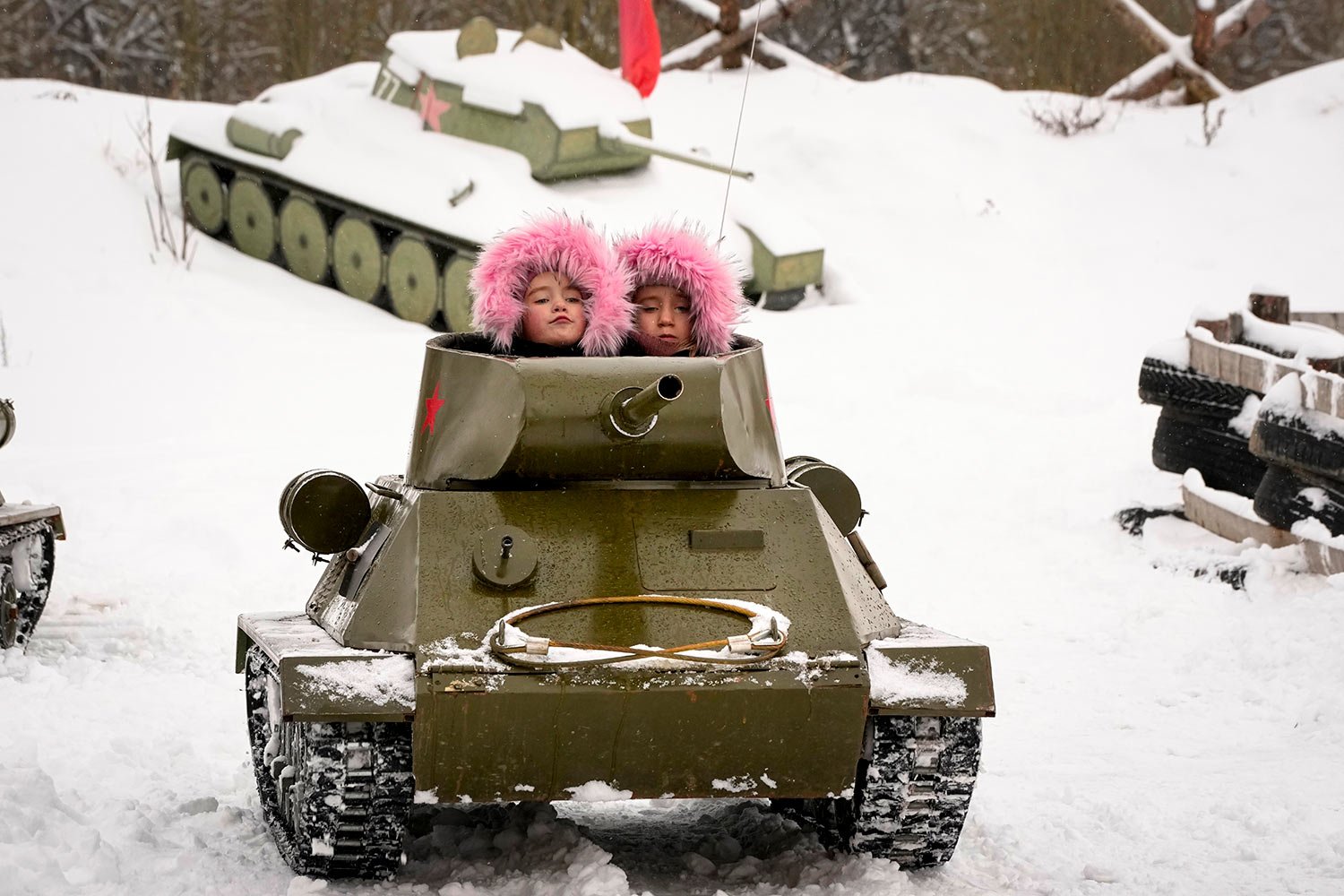  Children ride a model of World War II-era Soviet T-34 tank during a military historical festival at the family historical tank park outside St. Petersburg, Russia, Saturday, Feb. 4, 2023. (AP Photo/Dmitri Lovetsky) 