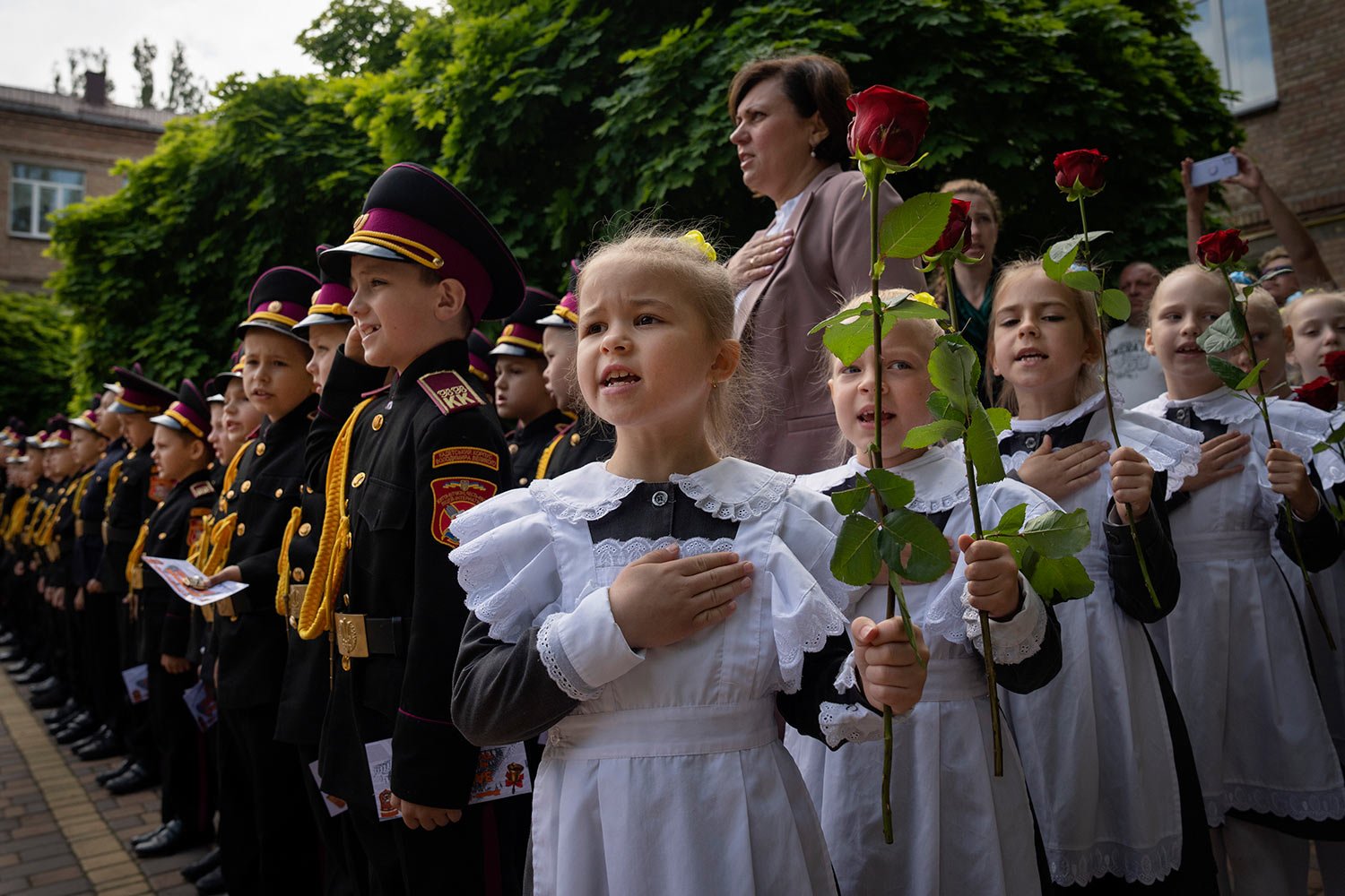  Young cadets sing the national anthem during a graduation ceremony in a cadet lyceum in Kyiv, Ukraine, Tuesday, June 13, 2023. (AP Photo/Efrem Lukatsky) 