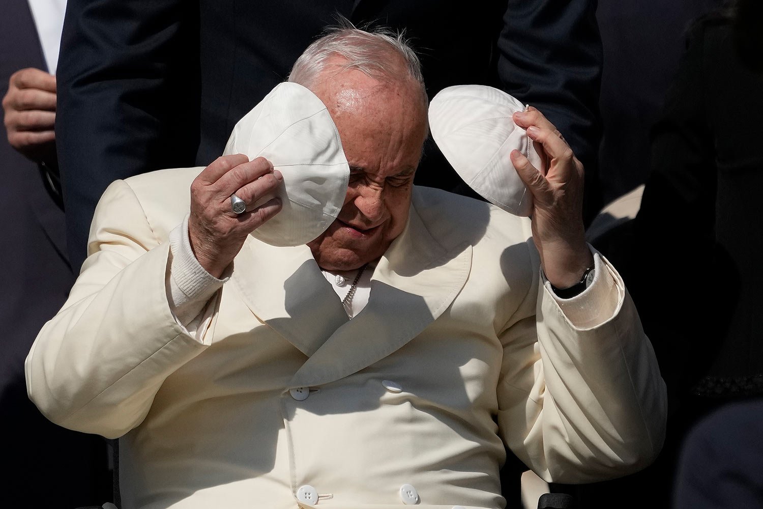  Pope Francis exchanges his skull cap with one presented by a participant in the weekly general audience in St. Peter's Square, at the Vatican, Wednesday, April 19, 2023. (AP Photo/Alessandra Tarantino) 