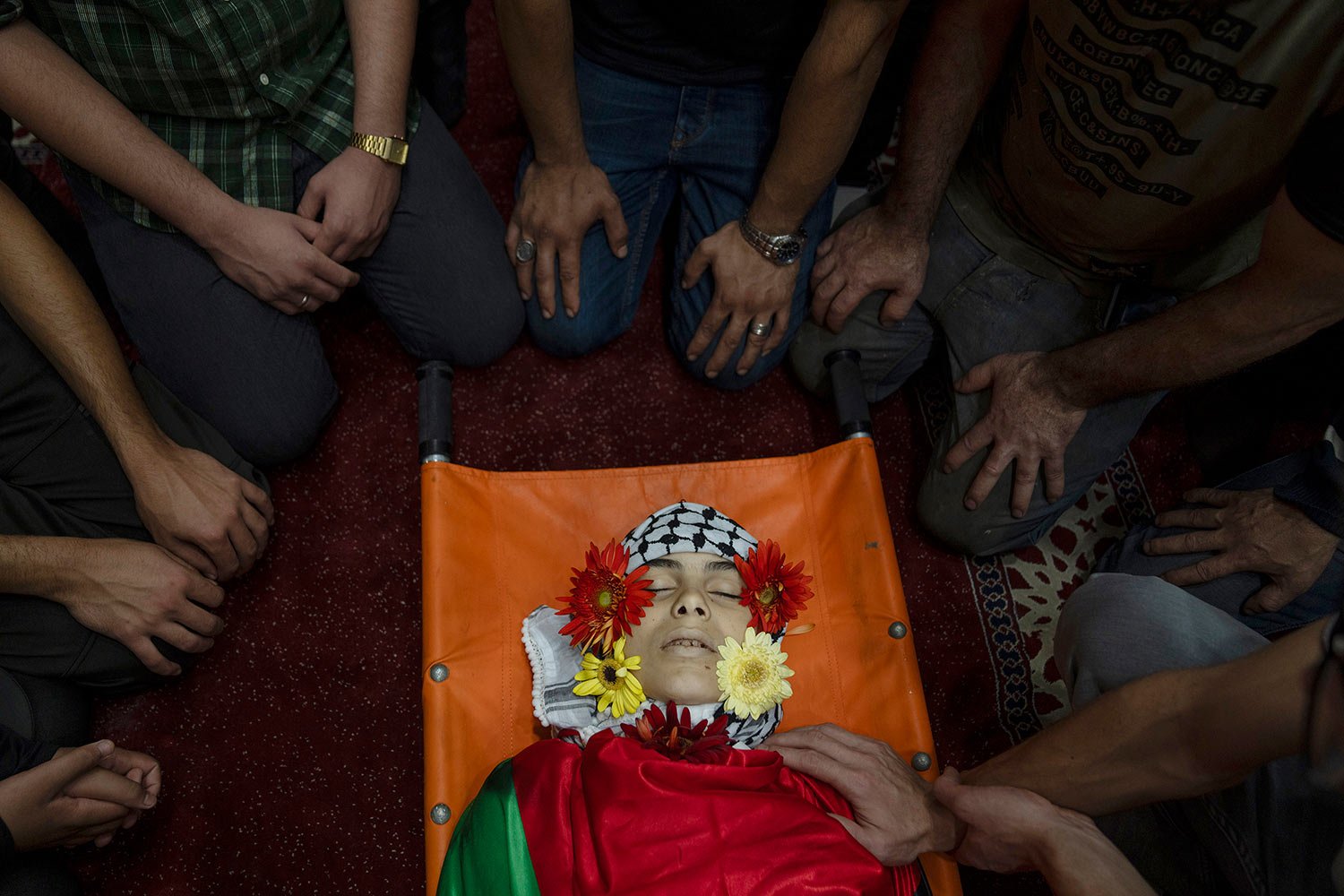  Palestinians take the last look at the body of Ayham Shafe'e, 14, during his funeral in the West Bank city of Ramallah, Thursday, Nov. 2, 2023. Shafee and a second Palestinian man were killed during an Israeli army raid in Ramallah, the Palestinian 