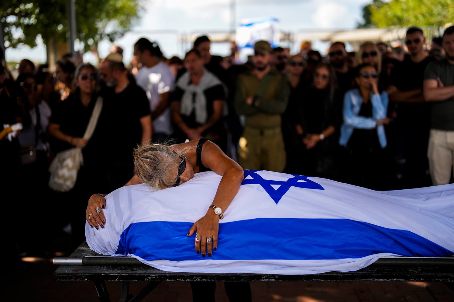  Antonio Macías' mother cries over her son's body covered with the Israeli flag at Pardes Haim cemetery in Kfar Saba, near Tel Aviv, Israel, Sunday, Oct. 15, 2023. Macias was killed by Hamas militants while attending a music festival in southern Isra