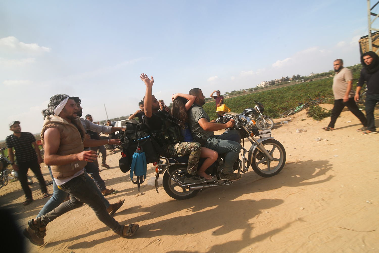  Hamas militants transport an Israeli woman taken from a kibbutz into the Gaza Strip on Saturday, Oct. 7, 2023.  (AP Photo) 