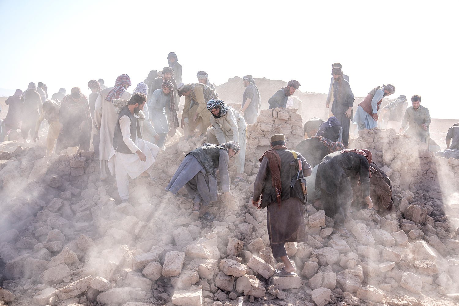  Afghan volunteers clean up rubble after an earthquake in Zenda Jan district in Herat province, western Afghanistan, Wednesday, Oct. 11, 2023. (AP Photo/Ebrahim Noroozi) 