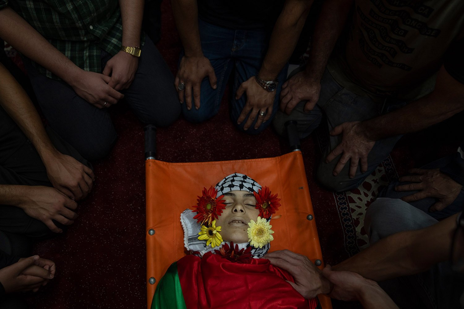  Palestinians take a last look at the body of Ayham Shafe’e, 14 during his funeral in the West Bank city of Ramallah, Thursday, Nov. 2, 2023. Shafee and a second Palestinian man were killed during an Israeli army raid in Ramallah early morning, the P