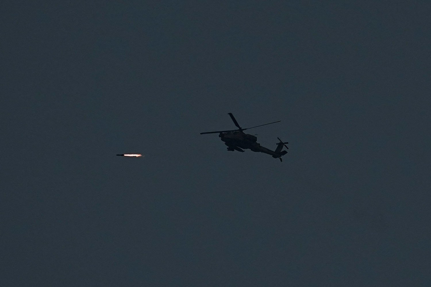  An Israeli Apache helicopter fires a missile towards the Gaza Strip, seen from southern Israel, Wednesday, Nov. 1, 2023. (AP Photo/Ariel Schalit) 