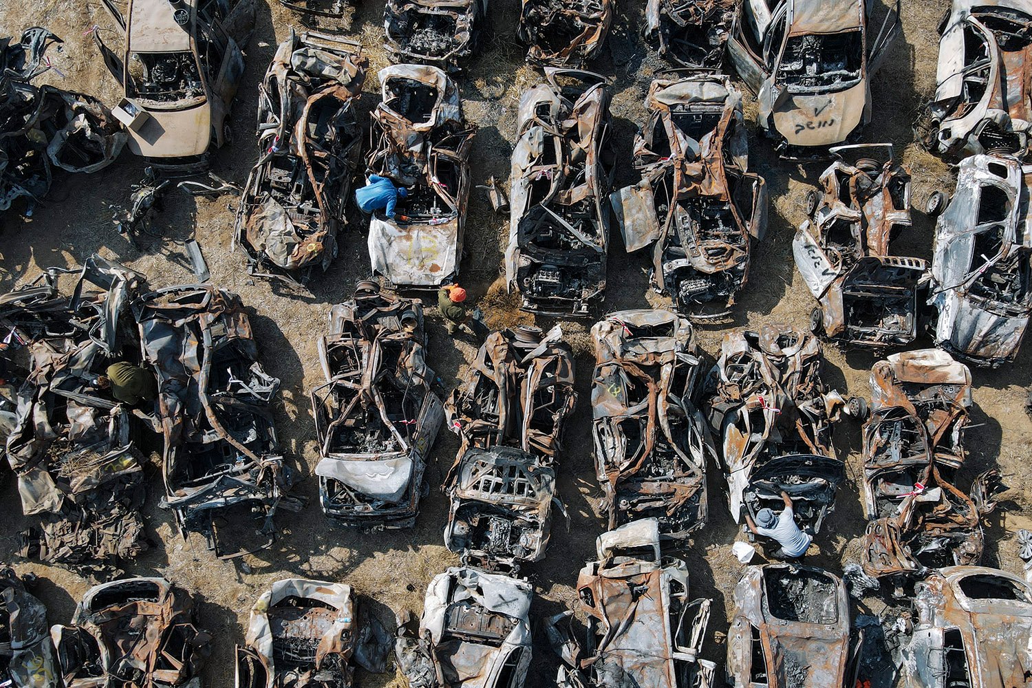  Israeli security forces inspect charred vehicles burned in the bloody Oct. 7 cross-border attack by Hamas militants, outside the town of Netivot, southern Israel. The vehicles were collected and placed in an area near the Gaza border after the attac