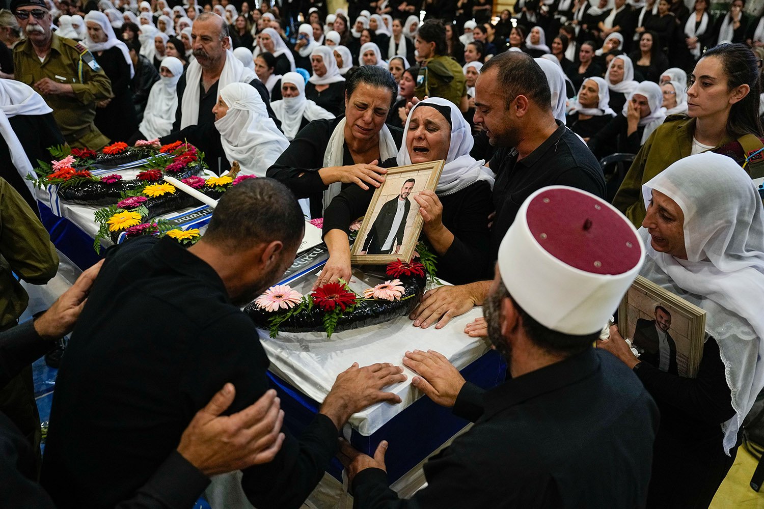  Mourners gather around the flag draped coffin of Druze Israeli Lieutenant colonel Salman Habaka in the village of Yanuh Jat, northern Israel, Friday, Nov. 3, 2023. Habaka was killed during a ground operation in the Gaza Strip. Israeli ground forces 