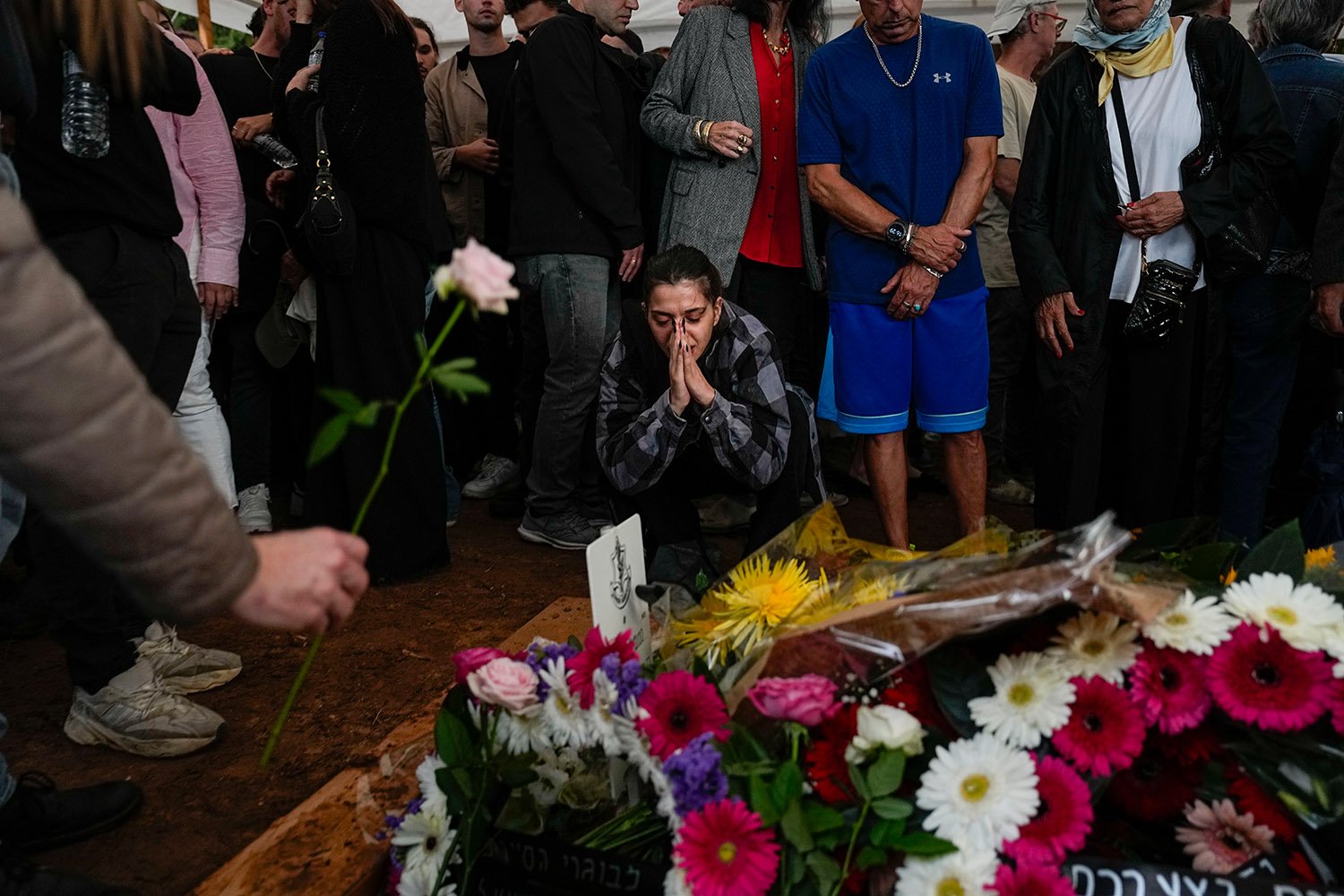  Mourners gather around the grave of Israeli reserve soldier Master sergeant Raz Abulafia at the end of his funeral in the village of Rishpon, Israel, Tuesday, Nov. 14, 2023. Abulafia, 27, was killed during a military ground operation in the Gaza Str