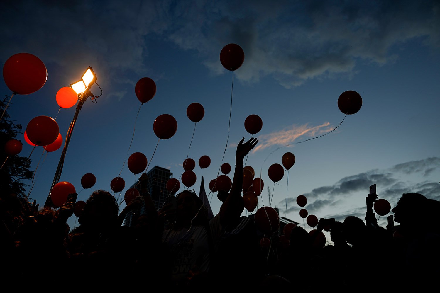  Protesters release balloons as they call for the release of the Bibas family, whose members are being held hostage in the Gaza Strip by the Hamas militant group, in Tel Aviv, Tuesday, Nov. 28, 2023. Hamas has released over 50 Israeli hostages in rec