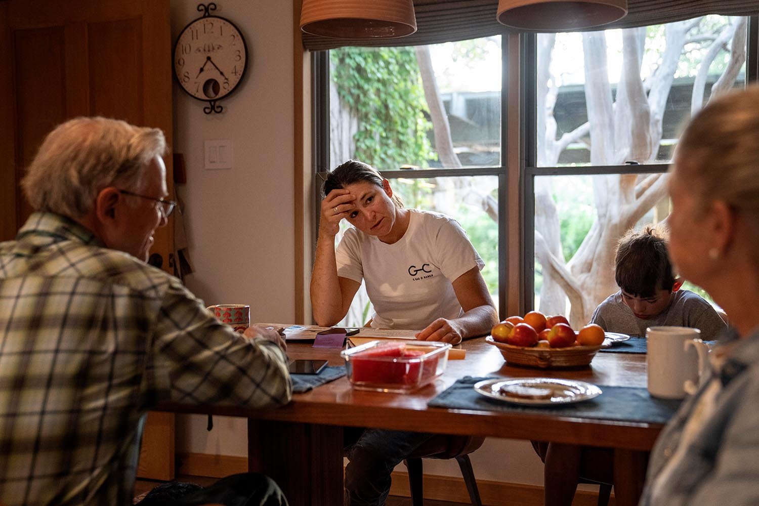  Meredith Ellis, center left, sits at the kitchen table next to her son, GC, 6, mother Mary,  right, and father, also named, GC, at their ranch in Rosston, Texas, Thursday, April 20, 2023. Ellis’ parents built this ranch and it’s where she was raised