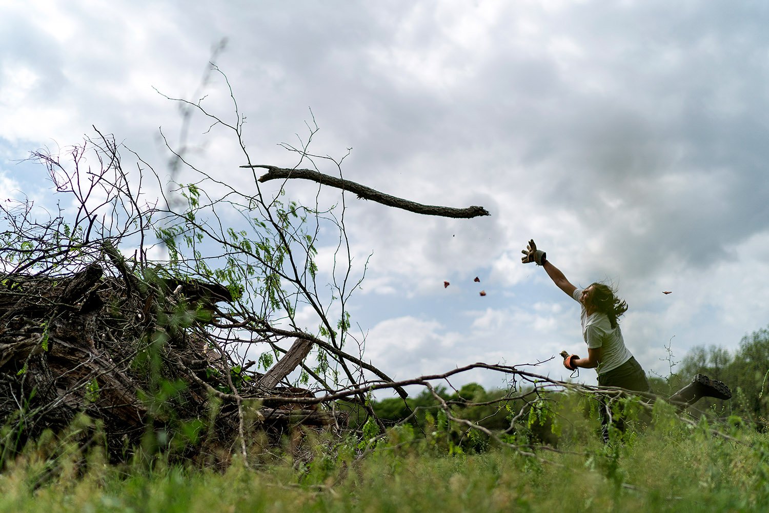 Meredith Ellis clears a field of branches so her cattle have more space to graze on her ranch in Rosston, Texas, Wednesday, April 19, 2023. (AP Photo/David Goldman)  