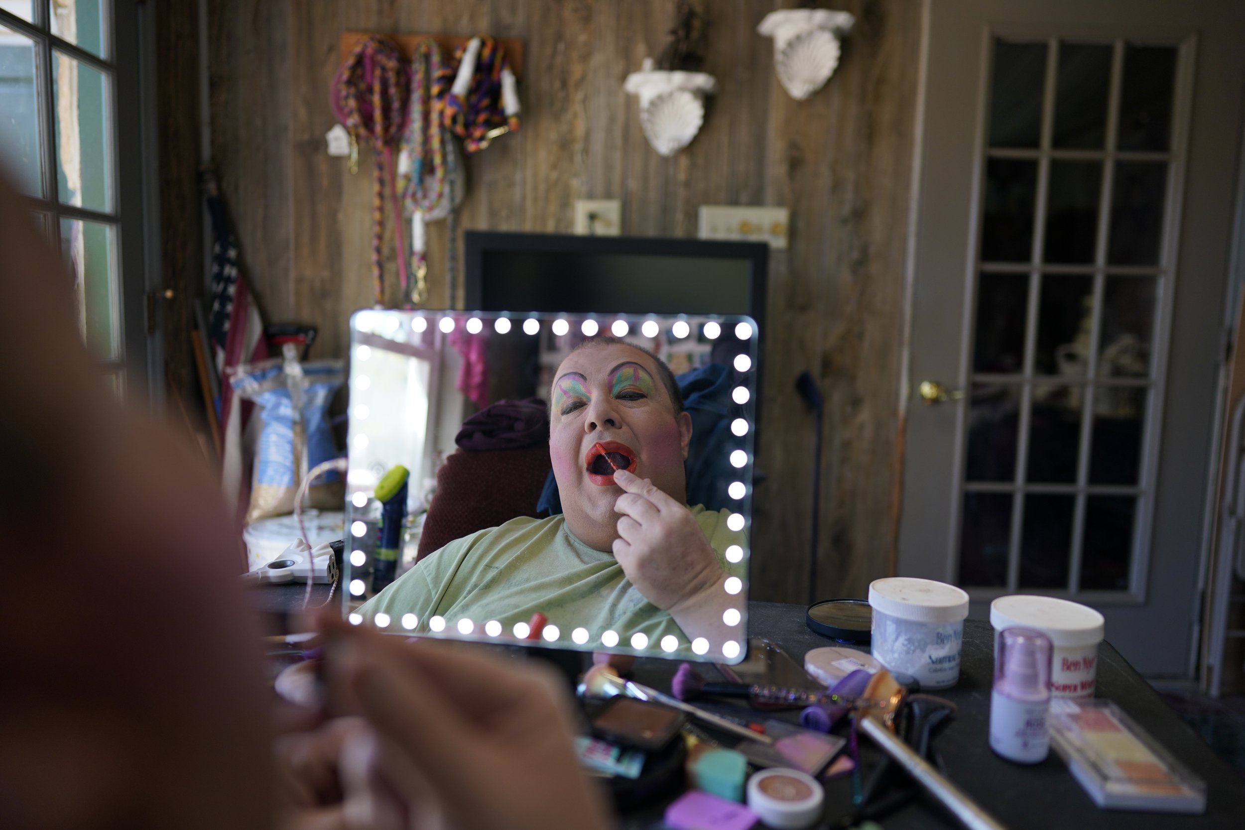  Drag queen Alexus Daniels is reflected in a mirror while applying makeup, or "painting," at home in Coal Township, Pa., on May 6, 2023. (AP Photo/Carolyn Kaster) 