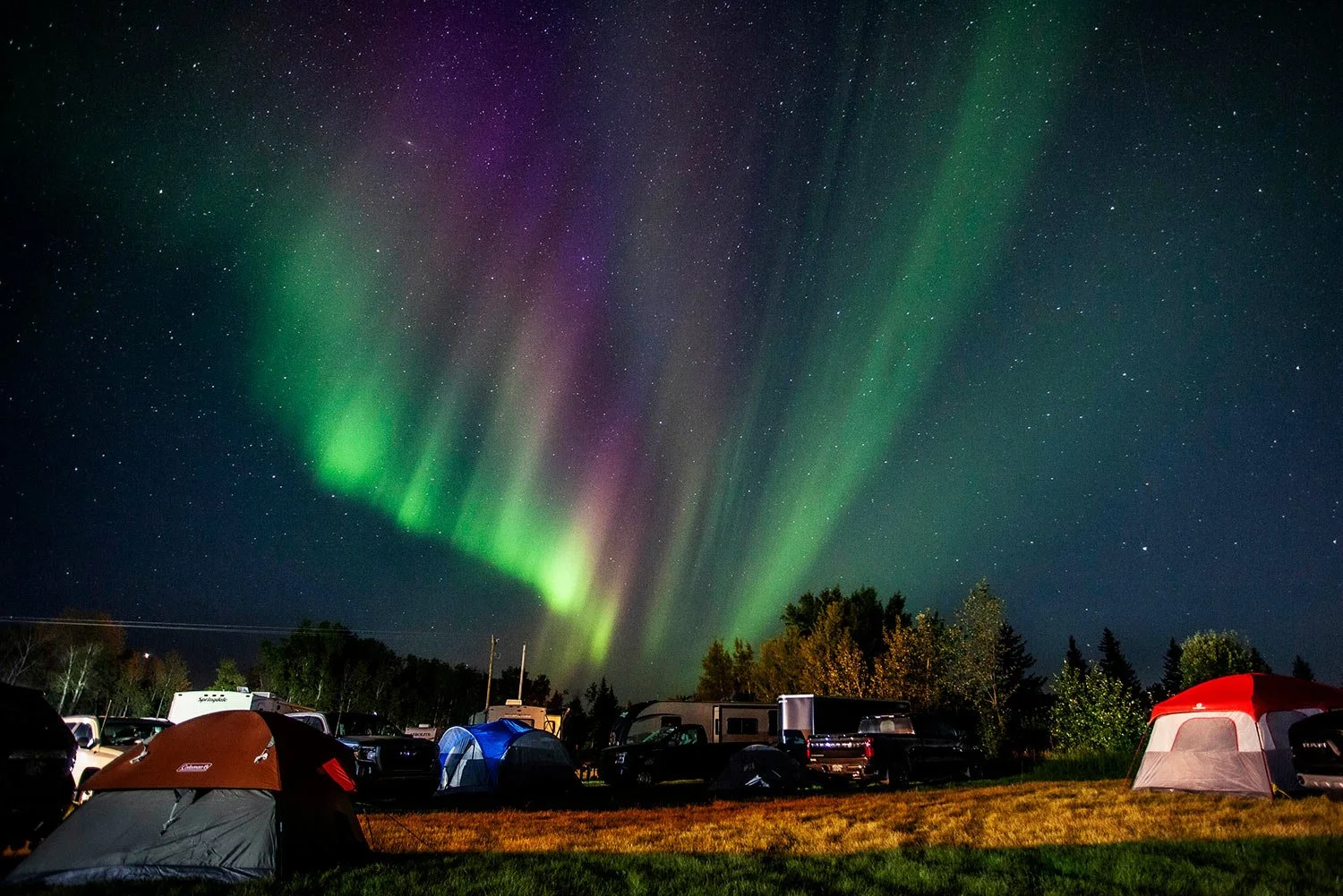  Evacuees from the wildfires in Yellowknife, territorial capital of the Northwest Territories, are greeted with the Aurora Borealis as they arrive at a free campsite provided by the community in High Level, Alberta, on Aug. 18, 2023. (Jason Franson /