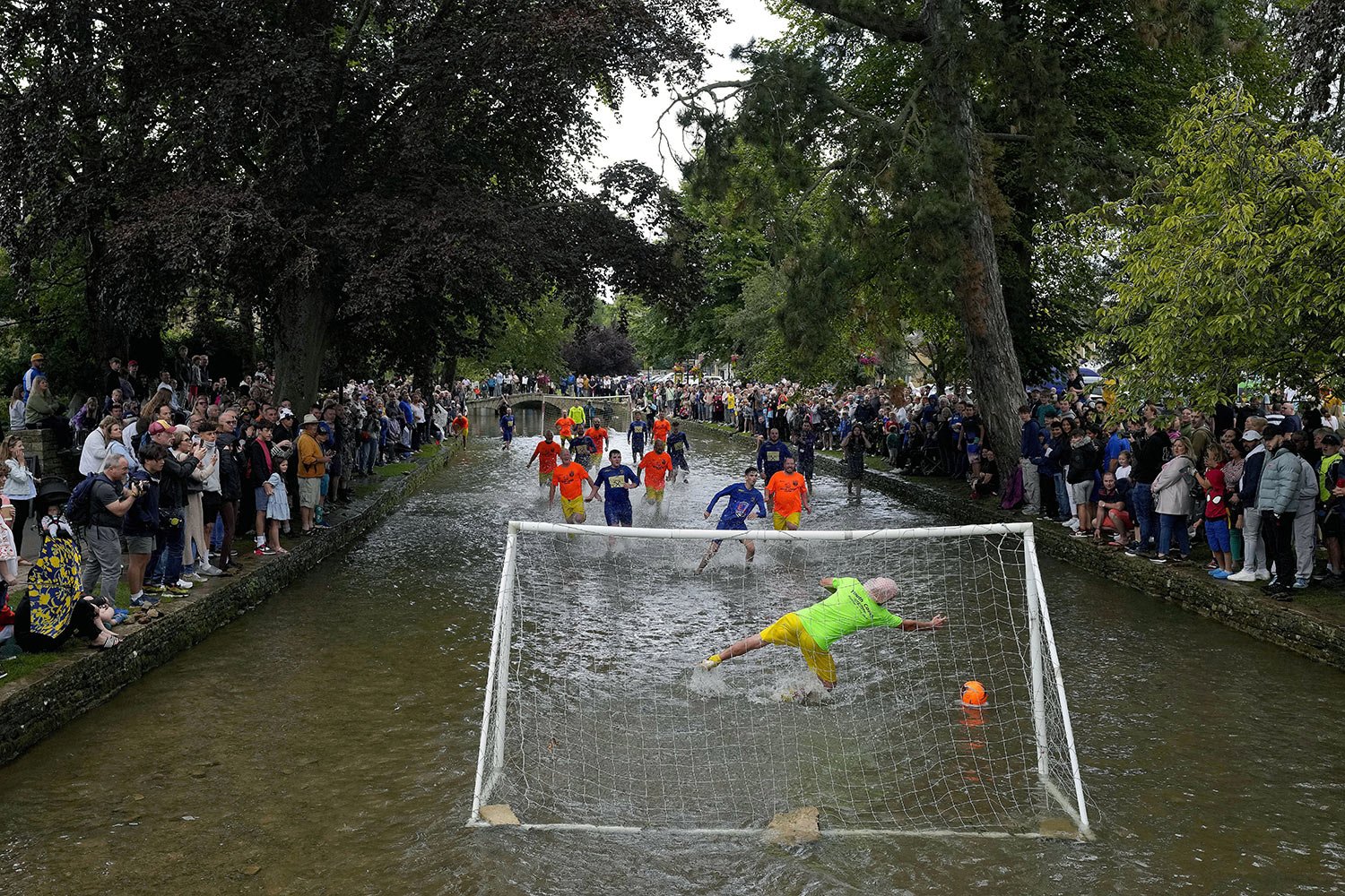  Bourton Rovers players compete during the annual traditional River Windrush soccer match, which has been taking place for over 100 years, in the Cotswolds village of Bourton-on-the-Water, England, Aug. 28, 2023. The event sees two teams of six from 
