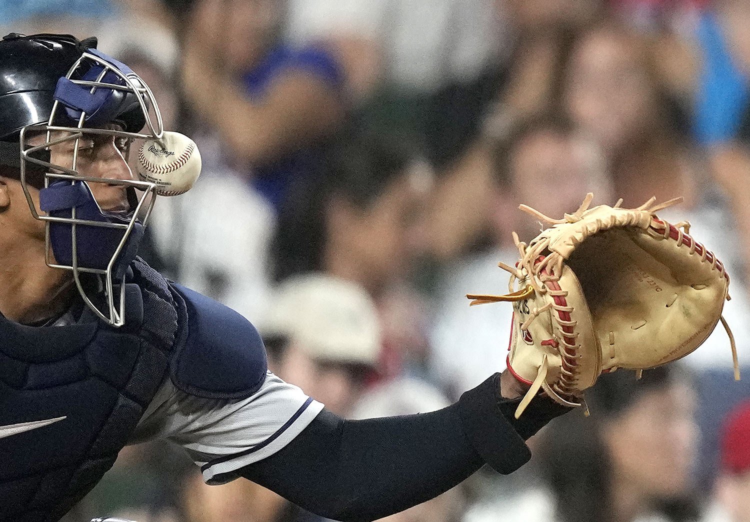  Cleveland Guardians catcher Bo Naylor is hit on his mask by a ball fouled off Chicago Cubs' Seiya Suzuki, in the fourth inning of a baseball game in Chicago, July 1, 202,. (AP Photo/Charles Rex Arbogast) 