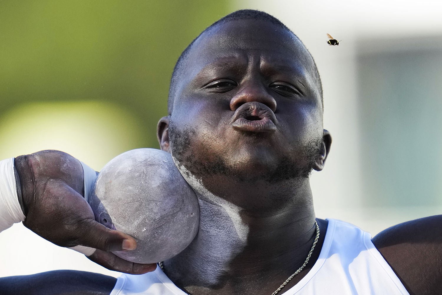  Josh Awotunde blows away an insect as he competes in the men's shot put during the U.S. track and field championships in Eugene, Ore., July 9, 2023. (AP Photo/Ashley Landis) 