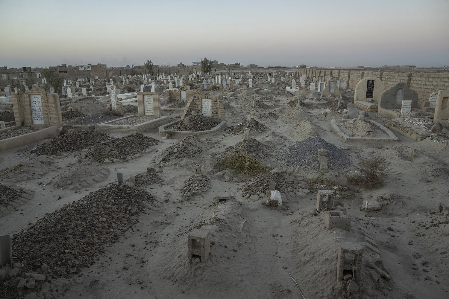  An Afghan Shiite cemetery, where a large number of Shiite migrants who were killed while trying to cross the border are buried, lies on the outskirts of Zaranj city, Afghanistan, Dec. 25, 2023. (AP Photo/Ebrahim Noroozi) 