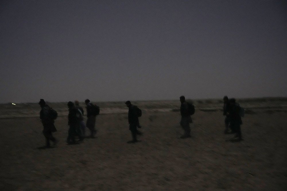  Young Shiite Afghan immigrants treck towards the the Iran-Afghanistan border wall in the desert around the city of Zaranj, Afghanistan, near the the Iran-Afghanistan border wall, to try to cross over the Iranian border wall into Iran, Dec. 25, 2023.