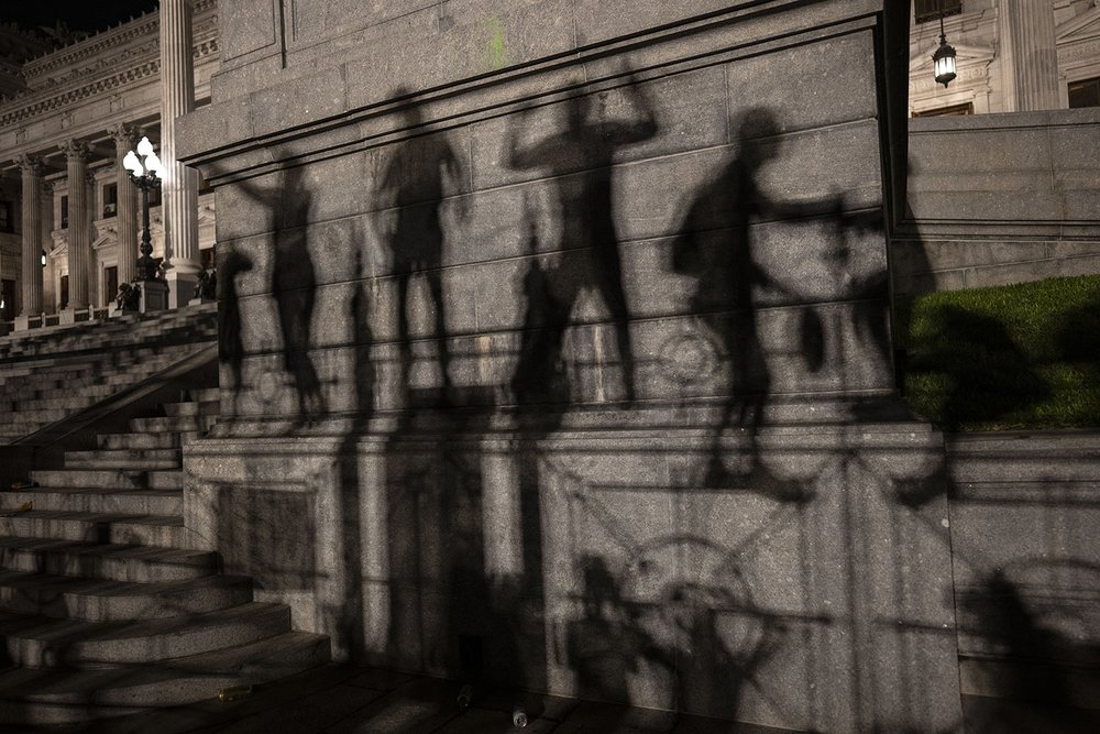  The silhouettes of anti-government demonstrators are cast on the National Congress building as they protest against government economic measures of President Javier Milei in Buenos Aires, Argentina, early Dec. 21, 2023. (AP Photo/Rodrigo Abd) 