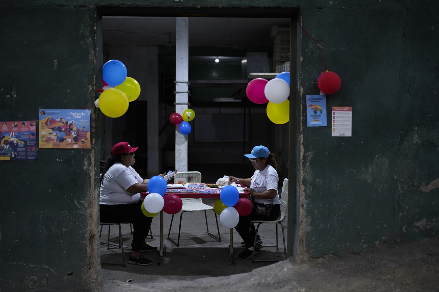  Ruling party community leaders sort election material on the Essequibo region, during a referendum on the future of the disputed territory with Guyana, in Caracas, Venezuela, Dec. 3, 2023. (AP Photo/Ariana Cubillos) 