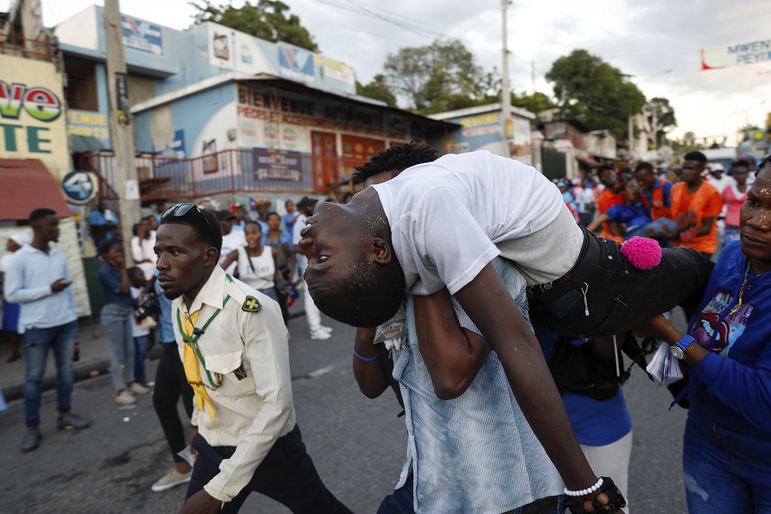  A person who fainted during a procession for Catholic feast of the Immaculate Conception is carried away in Port-au-Prince, Haiti, Dec. 8, 2023. (AP Photo/Odelyn Joseph) 