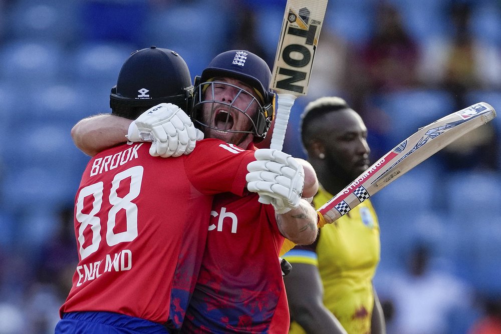  England's batsmen Harry Brook, left, and Phil Salt celebrate their victory over West Indies' by seven wickets with one ball remaining during the third T20 cricket match in Saint George's, Grenada, Dec. 16, 2023. (AP Photo/Ricardo Mazalan) 