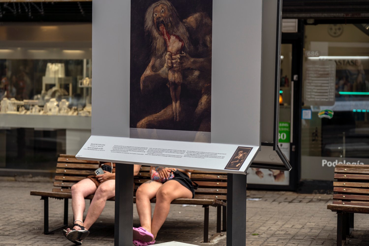  A replica of Saturn Devouring his Son by Francisco de Goya is displayed outside a storefront as part of an outdoor exhibit organized by the Prado Museum, in downtown Montevideo, Uruguay, Jan. 9, 2024. (AP Photo/Matilde Campodonico) 
