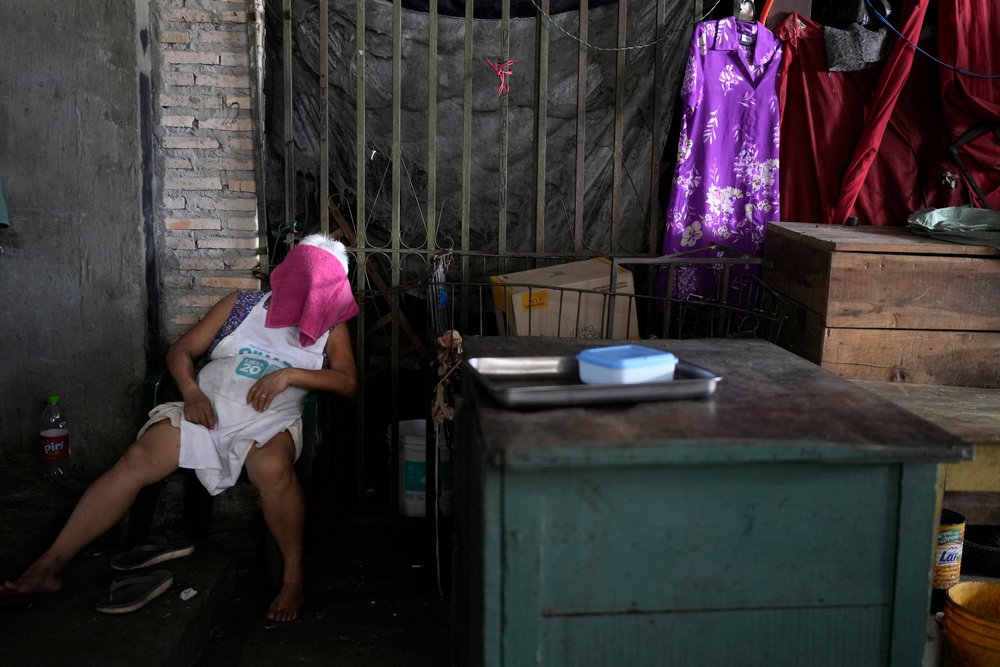  A Market 4 worker takes a nap on a hot summer day in Asuncion, Paraguay, Jan. 16, 2024. (AP Photo/Jorge Saenz) 