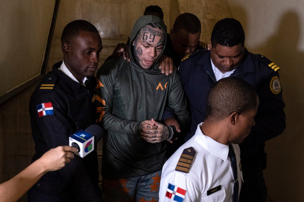  Rapper Daniel Hernandez, known as Tekashi 6ix9ine, is escorted by police at the Palace of Justice, in Santo Domingo, Dominican Republic, Jan. 20, 2024. Authorities arrested the rapper on Jan. 17 on charges of domestic violence. (AP Photo/Ricardo Her