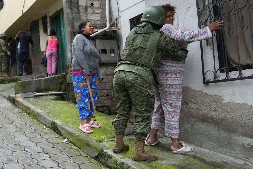  Soldiers search women as they patrol the south side of Quito, Ecuador, Jan. 12, 2024, in the wake of the apparent escape of a powerful gang leader from prison. President Daniel Noboa decreed a national state of emergency, a measure that lets authori