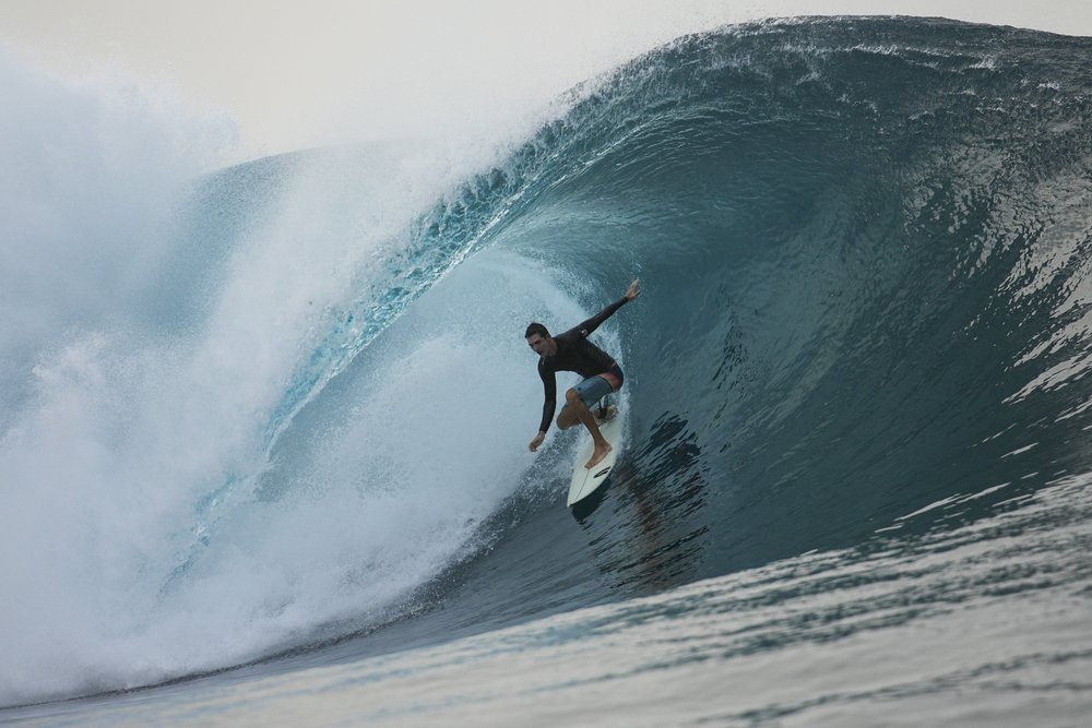 A surfer rides a wave in Teahupo'o, Tahiti, French Polynesia, Saturday, Jan. 13, 2024.  (AP Photo/Daniel Cole) 