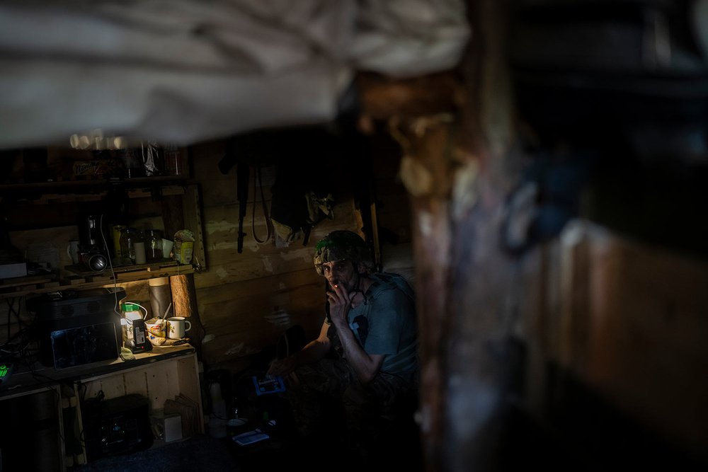  A Ukrainian soldier sits in a trench on the front line on the outskirts of Kreminna, Ukraine, Wednesday, Aug. 16, 2023. (AP Photo/Bram Janssen) 