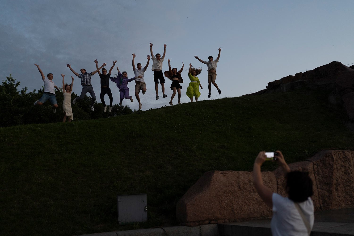 A group of recent high school graduates leap as they pose for photos to celebrate their graduation in Kyiv, Ukraine, Monday, July 3, 2023. (AP Photo/Jae C. Hong) 