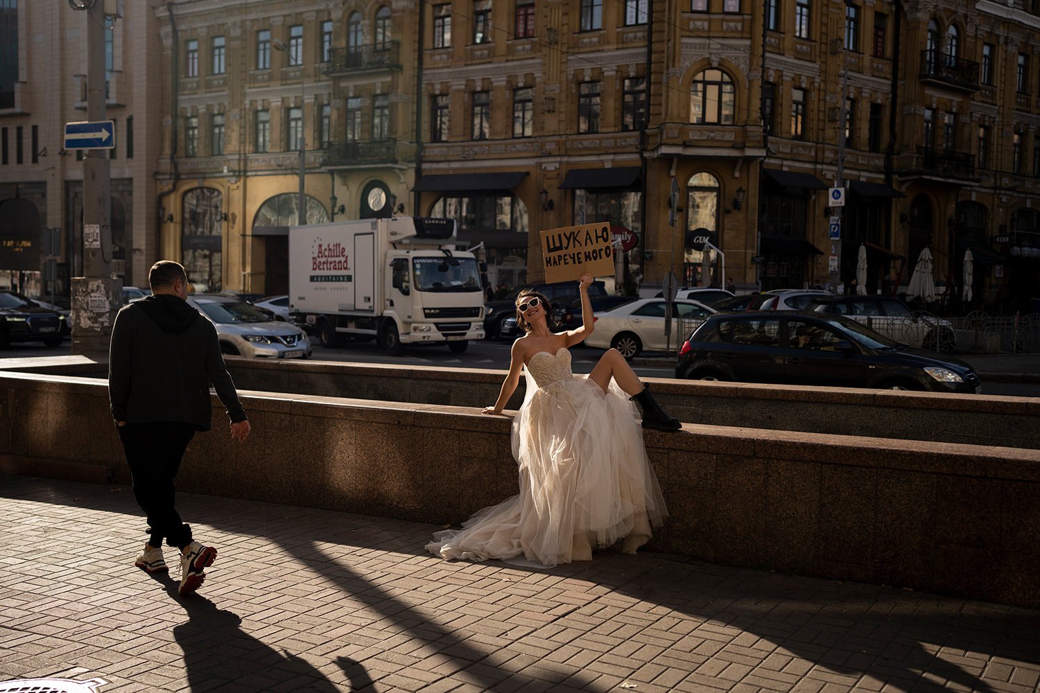  A woman poses for a social media campaign in Kyiv, Ukraine, Tuesday, Oct. 31, 2023. The sign reads, “Looking for a groom.” (AP Photo/Bram Janssen) 