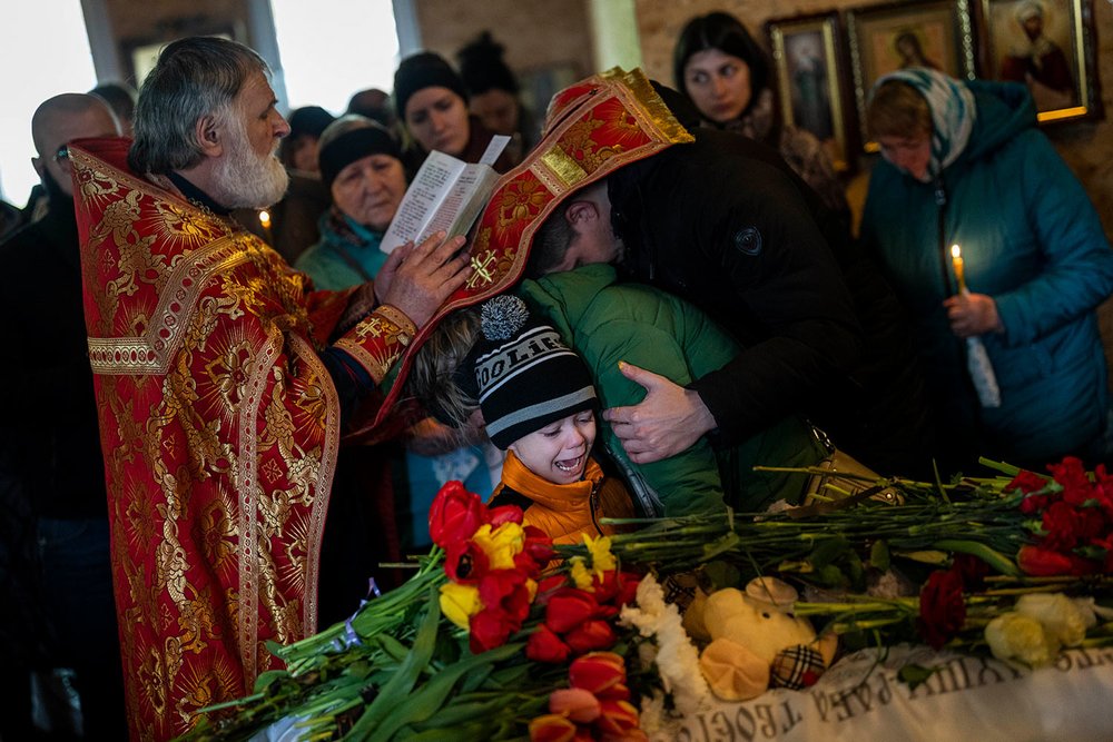 Mykhayl Shulha, center, cries next to the coffin of his sister Sofia Shulha during a funeral prayer in Uman, central Ukraine, Sunday, April 30, 2023. Sofia Shulha, 11, was killed in an attack on a residential building during the war with Russia. (AP