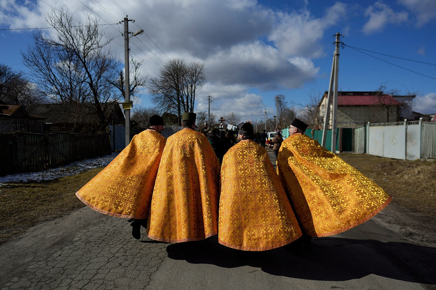  Priests walk to the cemetery during the funeral of Vladyslav Bondarenko in Kozyntsi, near Kyiv, Ukraine, Monday, March 6, 2023. Bondarenko, a paratrooper, died near Bakhmut. (AP Photo/Thibault Camus) 