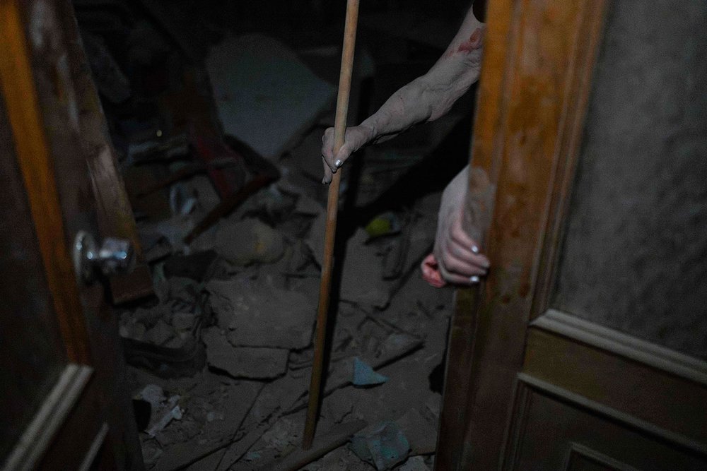  An elderly woman walks out of her destroyed apartment in Odesa, Ukraine, Sunday, July 23, 2023. (AP Photo/Jae C. Hong) 