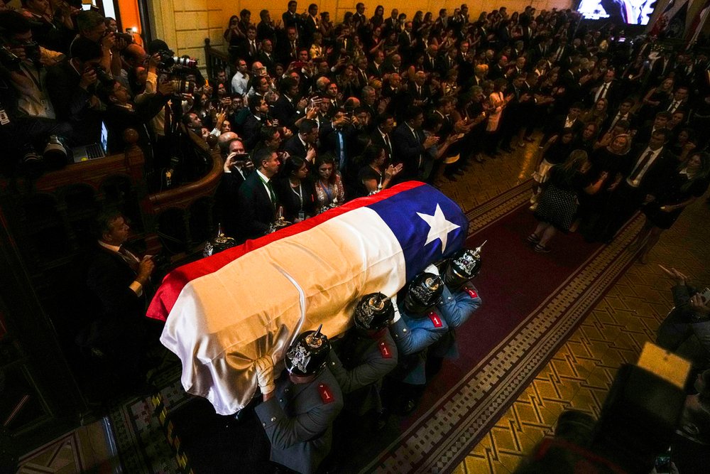  The flag-draped coffin of former Chilean President Sebastian Pinera is carried by honor guards out of Congress to La Moneda presidential palace in Santiago, Chile, Friday, Feb. 9, 2024. The two-time former president died on Feb. 6 in a helicopter cr