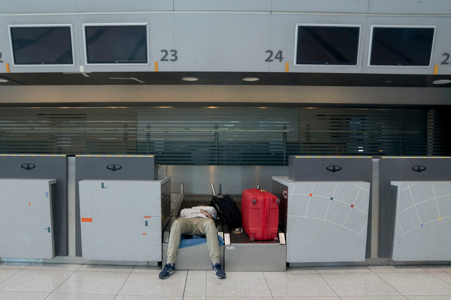  A passenger rests in a check-in area after his flight was suspended at Ezeiza airport due to a 24-hour airport worker strike for higher wages in Buenos Aires, Argentina, Wednesday, Feb. 28, 2024. (AP Photo/Victor R. Caivano) 