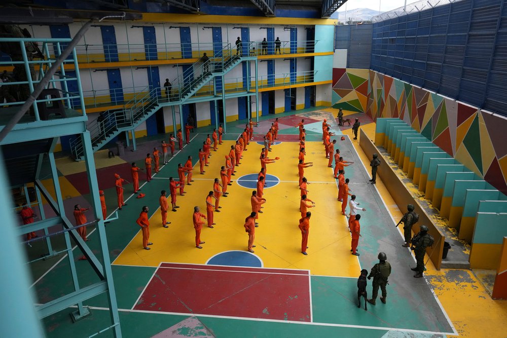  Soldiers stand guard as inmates exercise at the Cotopaxi prison during a press tour organized by the military in Latacunga, Ecuador, Thursday, Feb. 22, 2024. The military said the tour was to demonstrate they had regained control of the nation’s pri