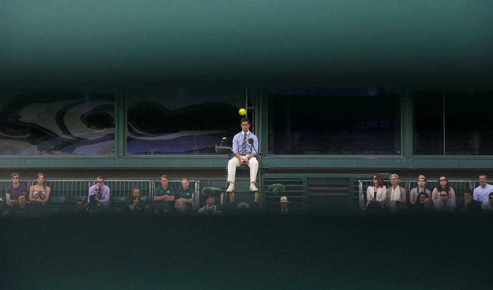  An umpire watches the ball as a match unfolds on Court 18, as seen through wooden slats, at the All England Lawn Tennis Championships in Wimbledon, London, Wednesday, June 26, 2013. (AP Photo/Anja Niedringhaus) 