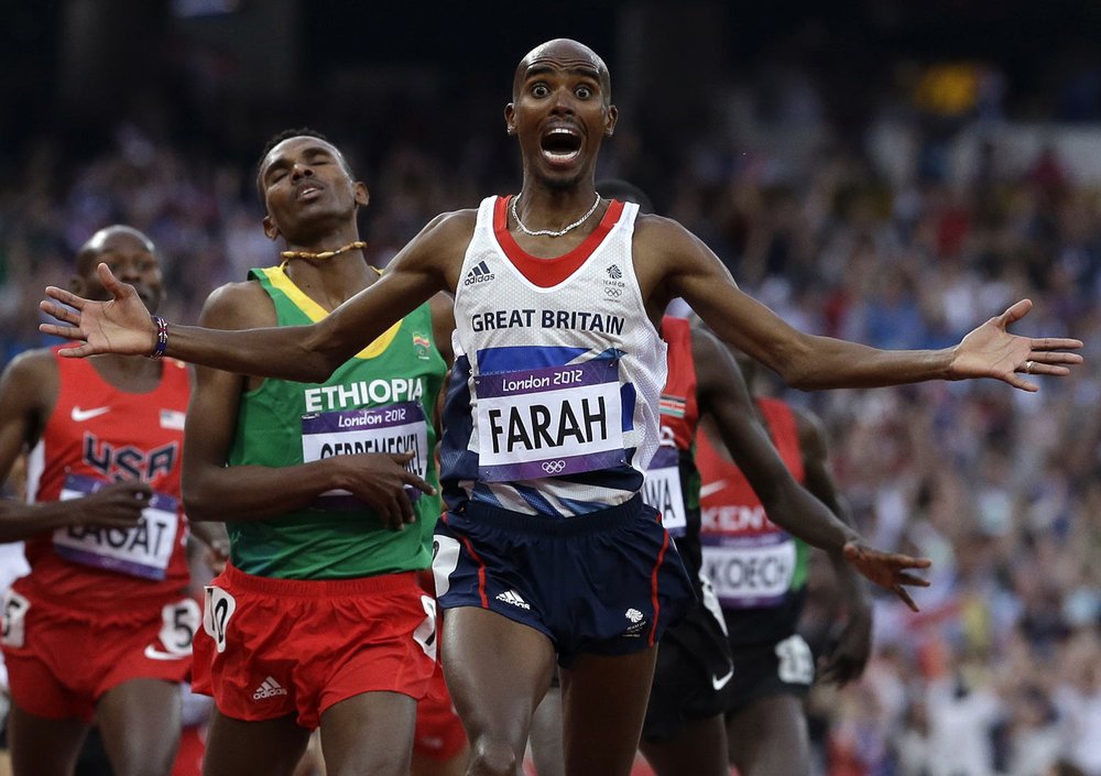  Britain's Mohamed Farah celebrates as he crosses the finish line to win the men's 5000-meter final during the athletics in the Olympic Stadium at the 2012 Summer Olympics, London, Saturday, Aug. 11, 2012. (AP Photo/Anja Niedringhaus) 