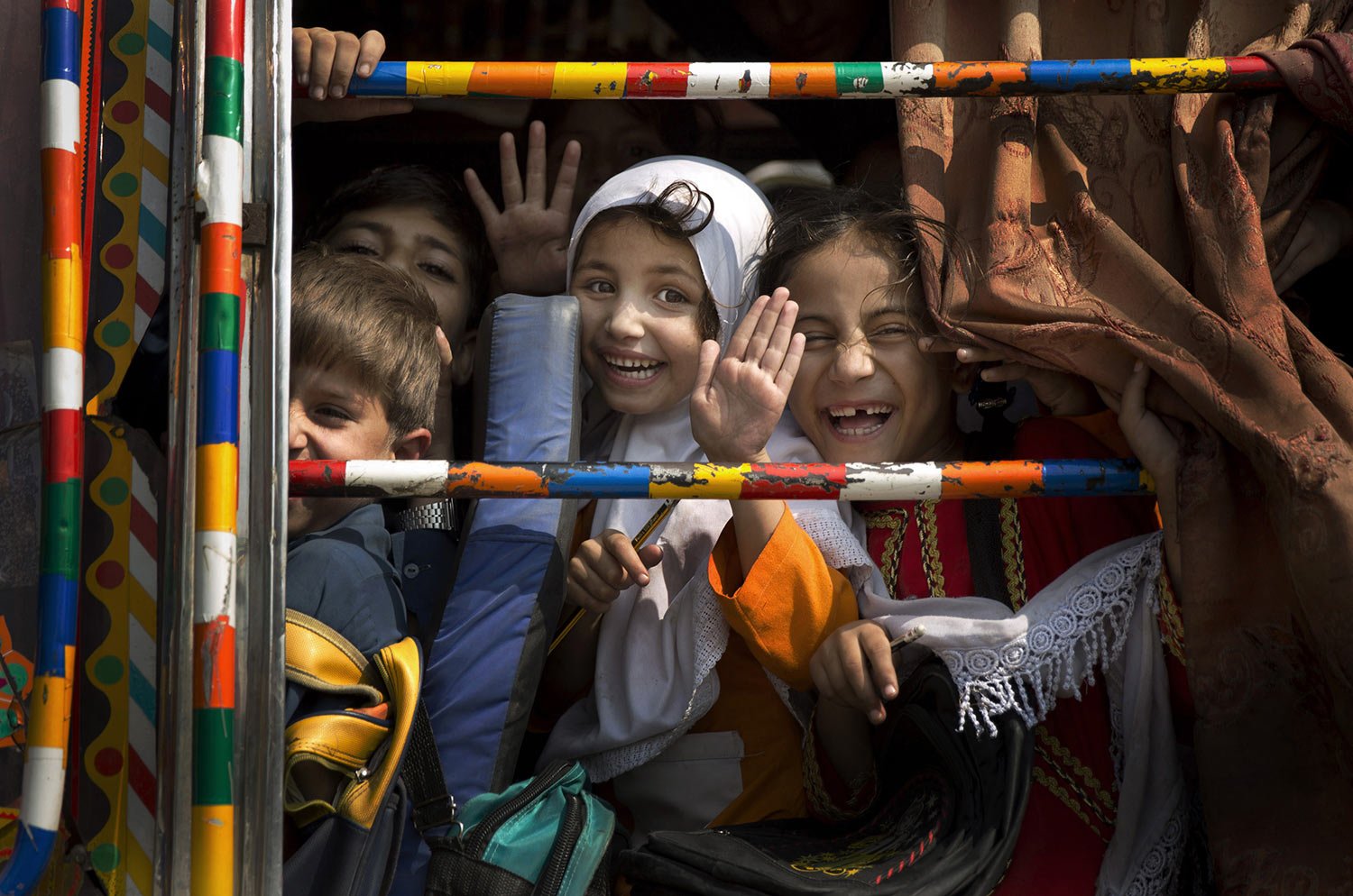  Children peek out of a bus as they leave school in Wajah Khiel, Swat Valley, Pakistan on Friday, Oct. 4, 2013. (AP Photo/Anja Niedringhaus, File) 