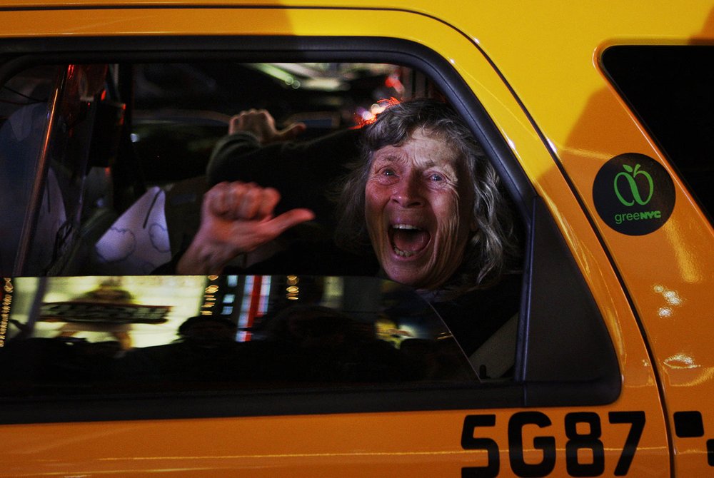  A woman reacts while sitting in a taxi as different television networks call the presidential race for Barack Obama, in New York on Tuesday, Nov. 4, 2008. (AP Photo/Anja Niedringhaus) 