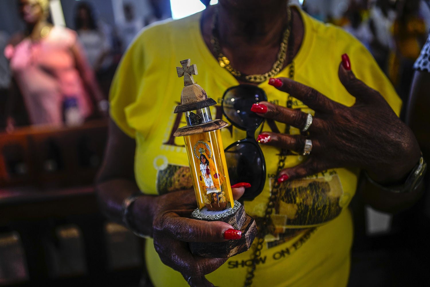  A person holds a statuette of the Virgin of Charity of Cobre during Mass at the Virgin's shrine in El Cobre, Cuba, Feb. 11, 2024. (AP Photo/Ramon Espinosa) 