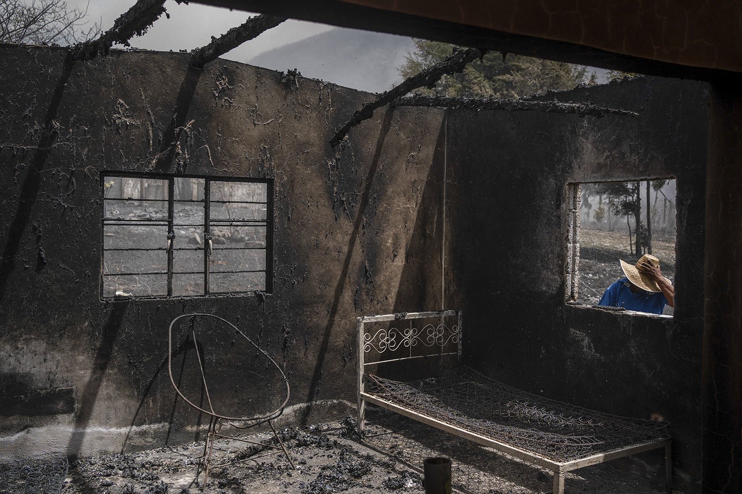  A resident looks at his home destroyed by wildfires in Maltrata, Mexico, March 25, 2024. (AP Photo/Felix Marquez) 