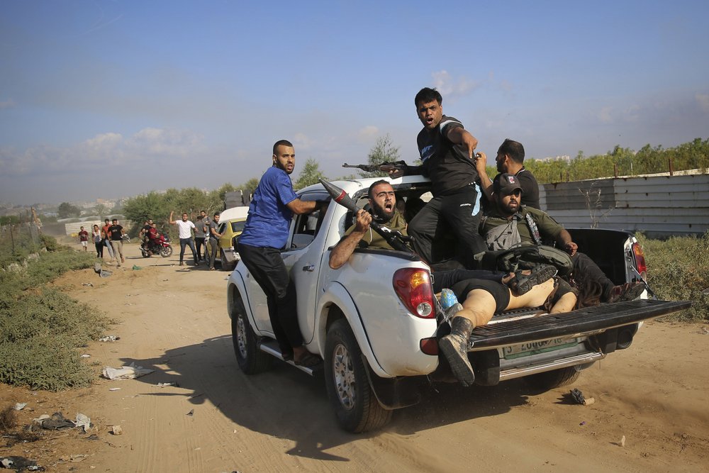  Palestinian militants drive back to the Gaza Strip with the body of Shani Louk, a German-Israeli dual citizen, during their cross-border attack on Israel, Saturday, Oct. 7, 2023. Photo by Ali Mahmud 