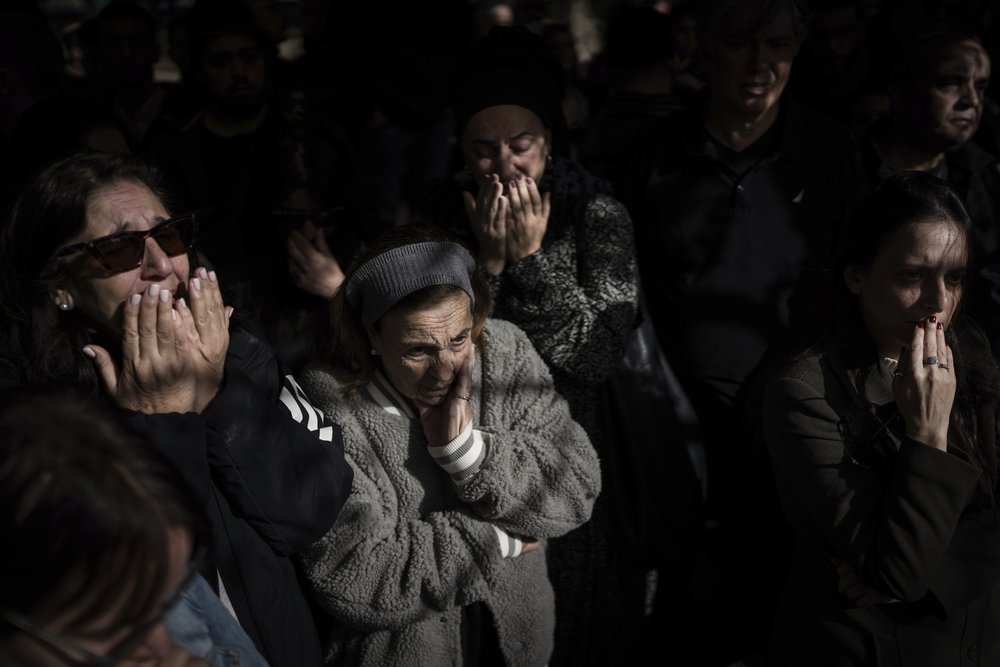 Family and friends of Israeli soldier Lt. Yaacov Elian mourn over his grave during his funeral at Kiryat Shaul cemetery in Tel Aviv, Israel, Friday, Dec. 22, 2023. Elian, 20, was killed during Israel's ground operation in the Gaza Strip, where it ha