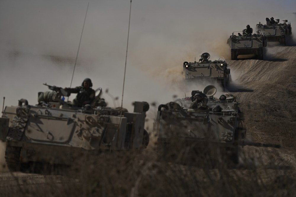  Israeli armored personnel carrrers head towards the Gaza Strip border in southern Israel on Friday, Oct.13, 2023. Photo by Ariel Schalit 